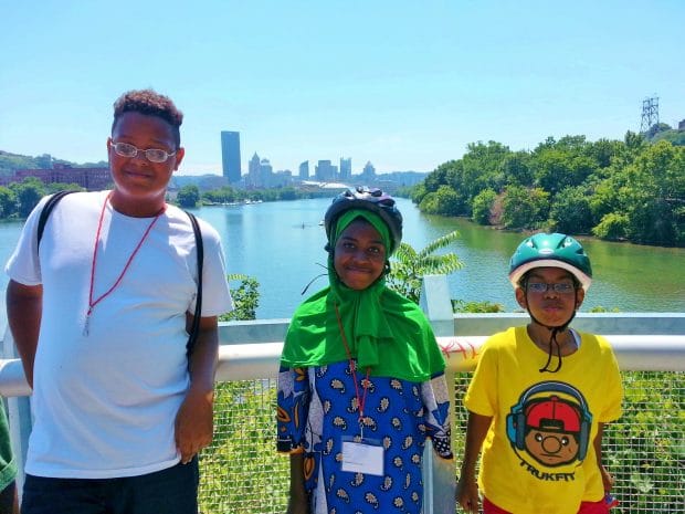 Positive Spinners at Summer Dreamer's Academy Pose In Front of the View of the City