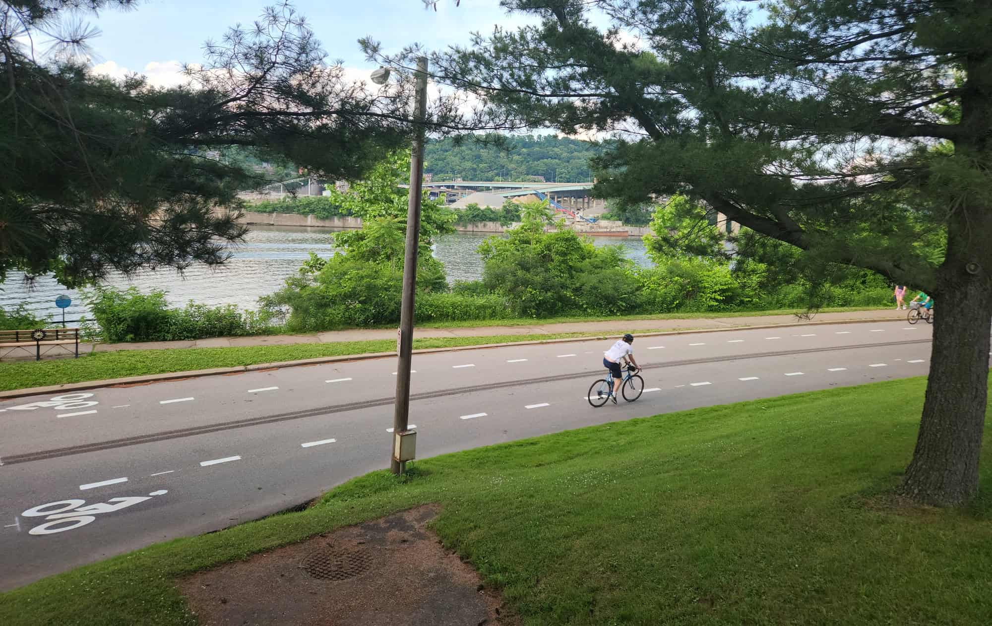 Image shows two bicyclists riding in the advisory bike lane