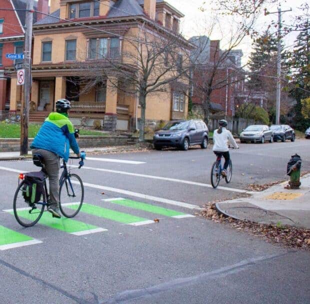 Picture of two cyclists on the Coral St neighborway.