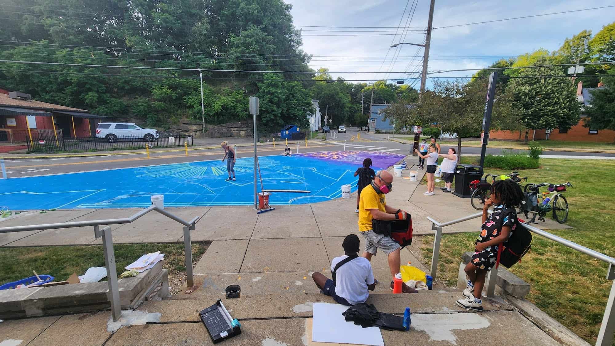 The artists at work on the asphalt mural