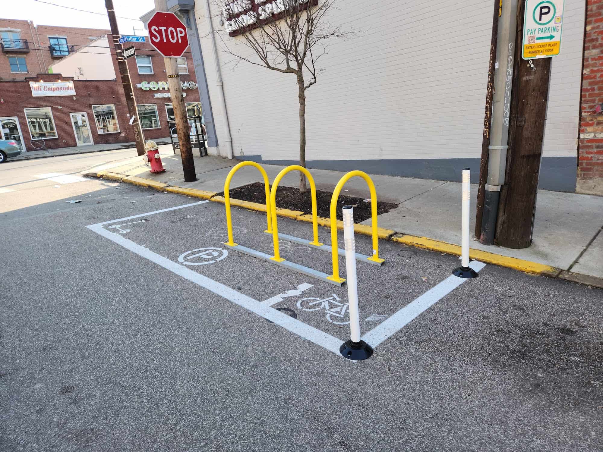 Image of a bike rack placed on the street to daylight an intersection