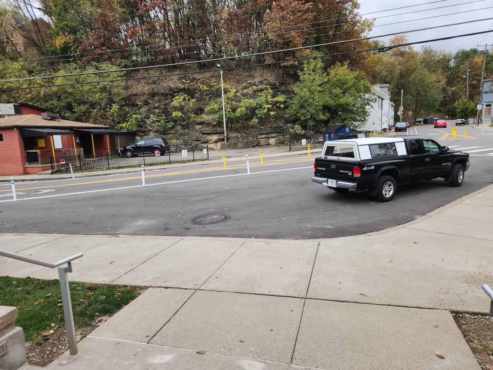 Image of a pickup truck parked in the street where the future street mural will be painted