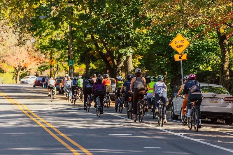 A group of women, trans and nonbinary cyclist enjoy a group bike ride.