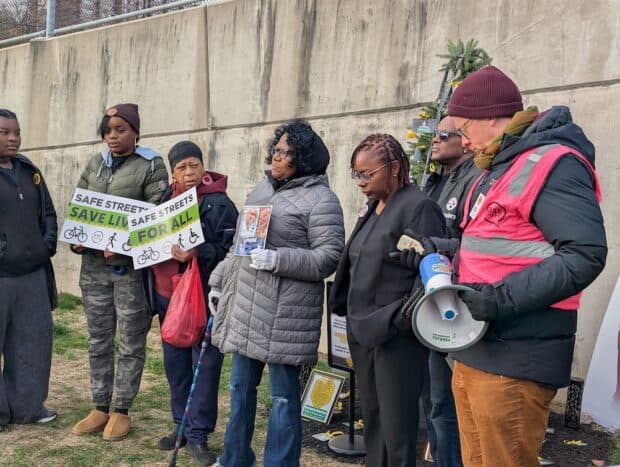 People bow their heads and observe a moment of silence.