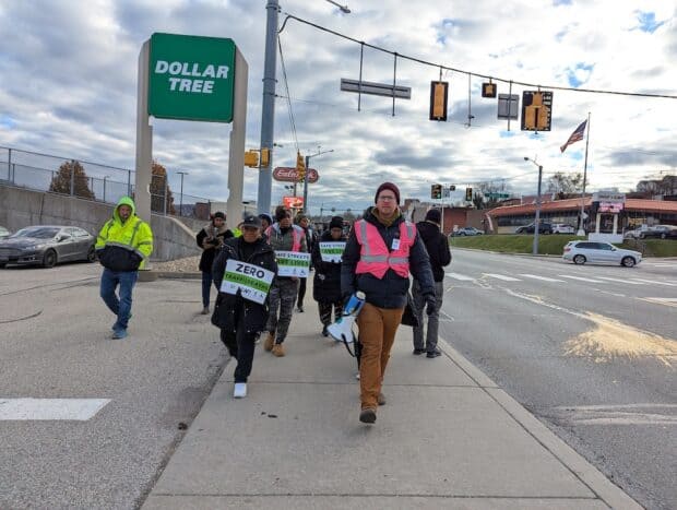 People walking down a sidewalk.