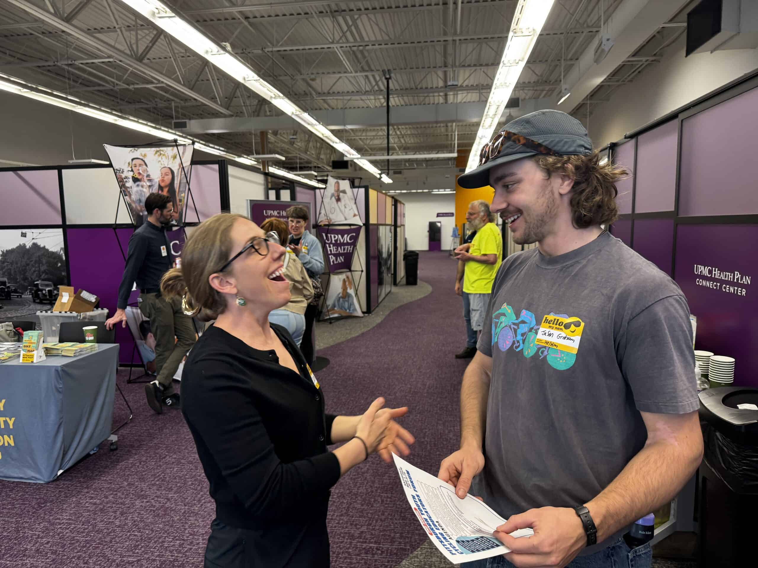 Two attendees chat and smile